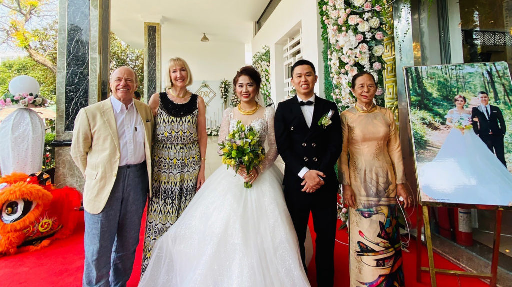 Clients with bride and groom at vietnamese wedding