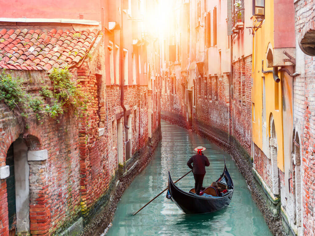 Gondolier in canal in Venice, Italy