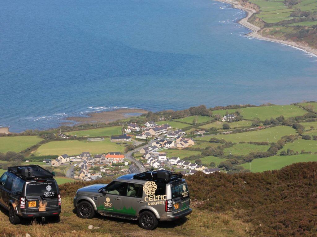 Land Rovers above coast, Wales