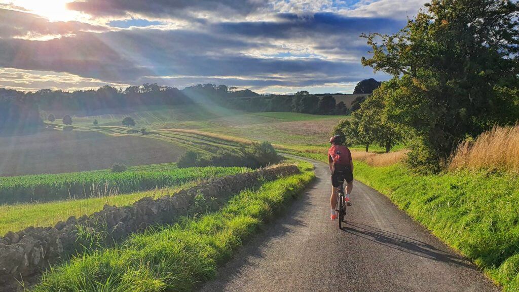 Cycling at golden hour in the Yanworth Valley, Cotswolds, England,  United Kingdom