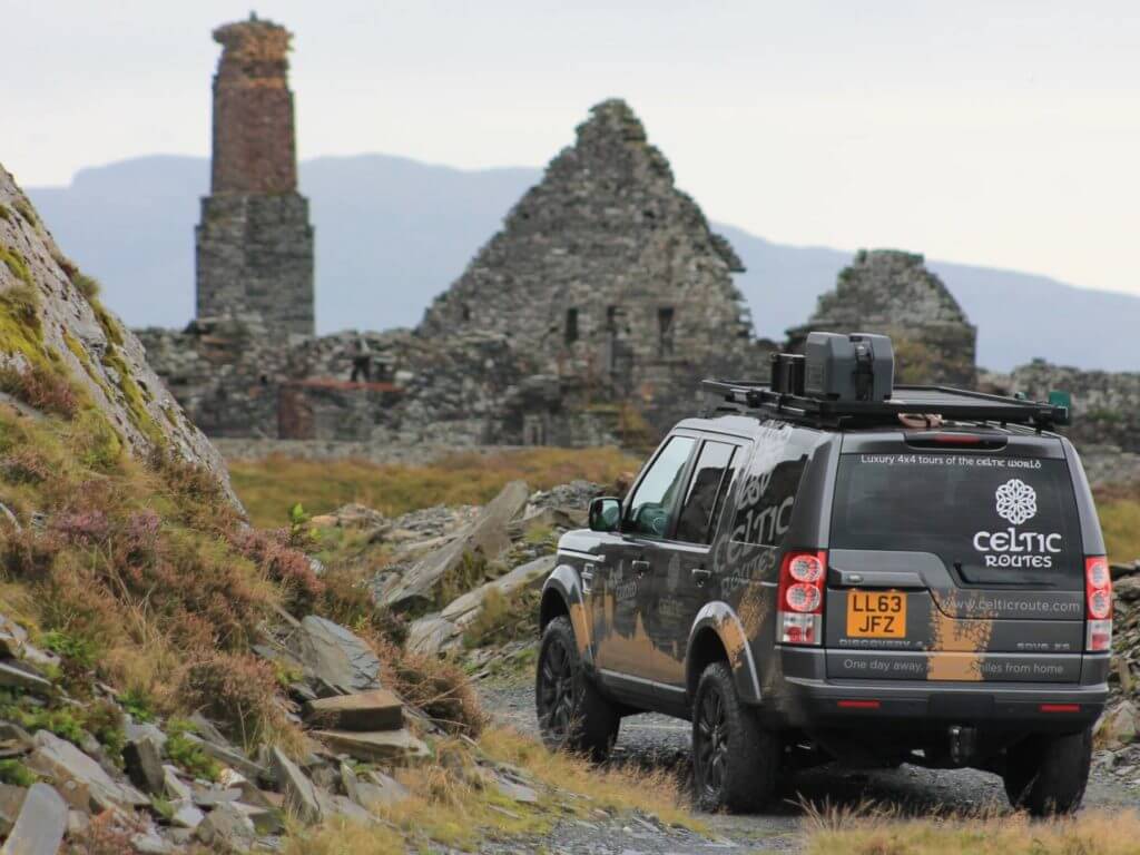 Land Rover in front of ruins, Wales