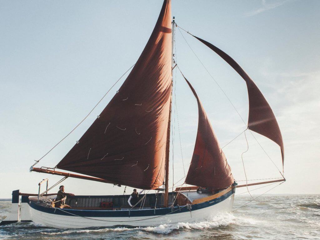 Whelk boat sailiing at sea, Norfolk, England