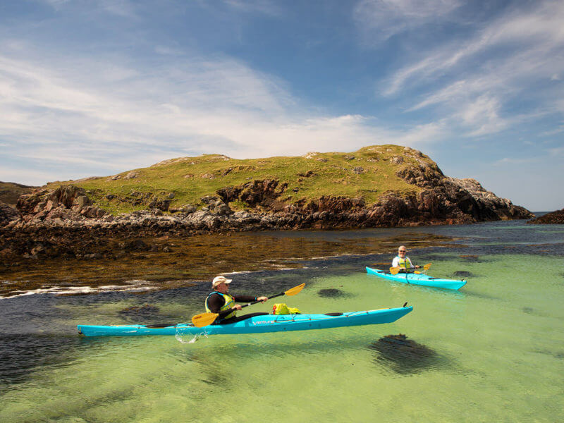 Two people kayaking off Oldany Island, Scotland