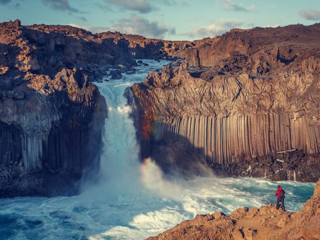 Waterfall with person in foreground, Iceland